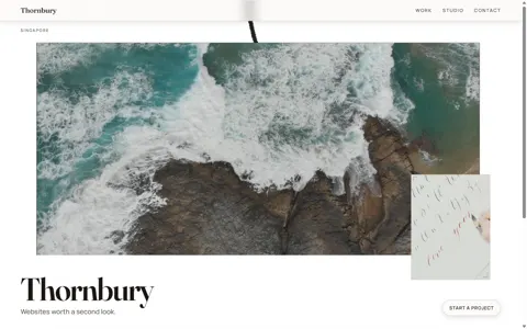 Thornbury Digital v4: an aerial window of waves on rock, a small calligraphy plate hanging off its corner, the wordmark Thornbury lower-left on warm paper with the line &lsquo;Websites worth a second look.&rsquo;