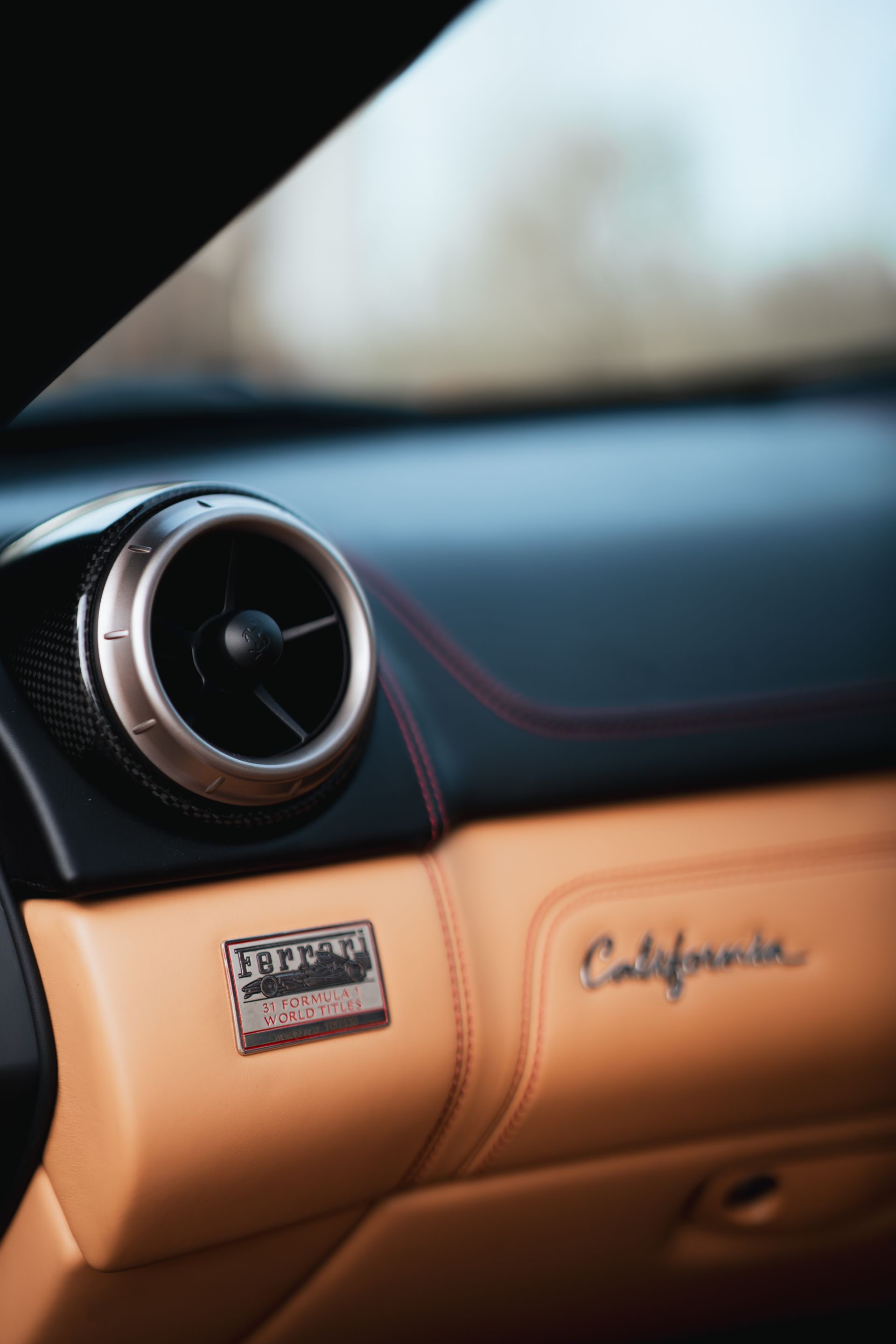 A machined air vent set into saddle leather and carbon fibre inside the K8 Aviator.