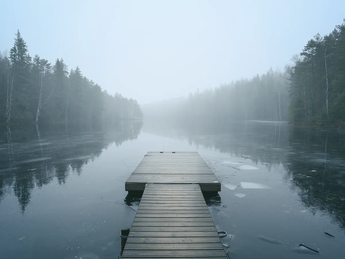 Lochside plot: a timber jetty running out into still water under morning mist