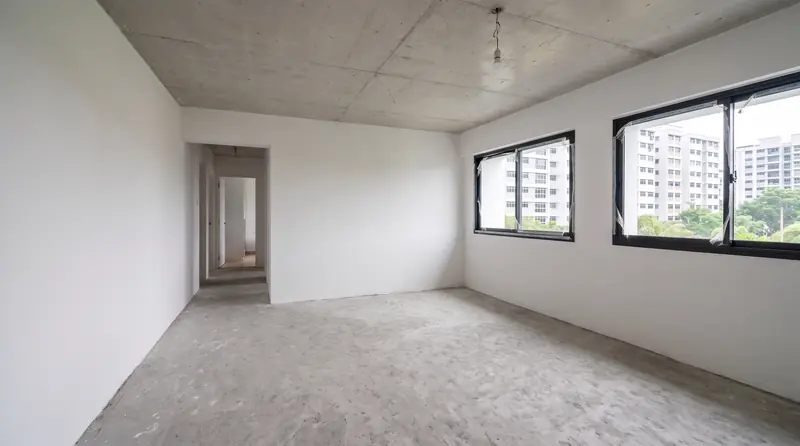Before: the same room as handed over, bare screed floor, plaster walls and one bulb holder.