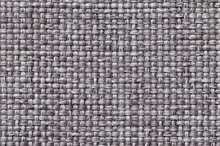 A close view of grey basket-weave upholstery cloth.