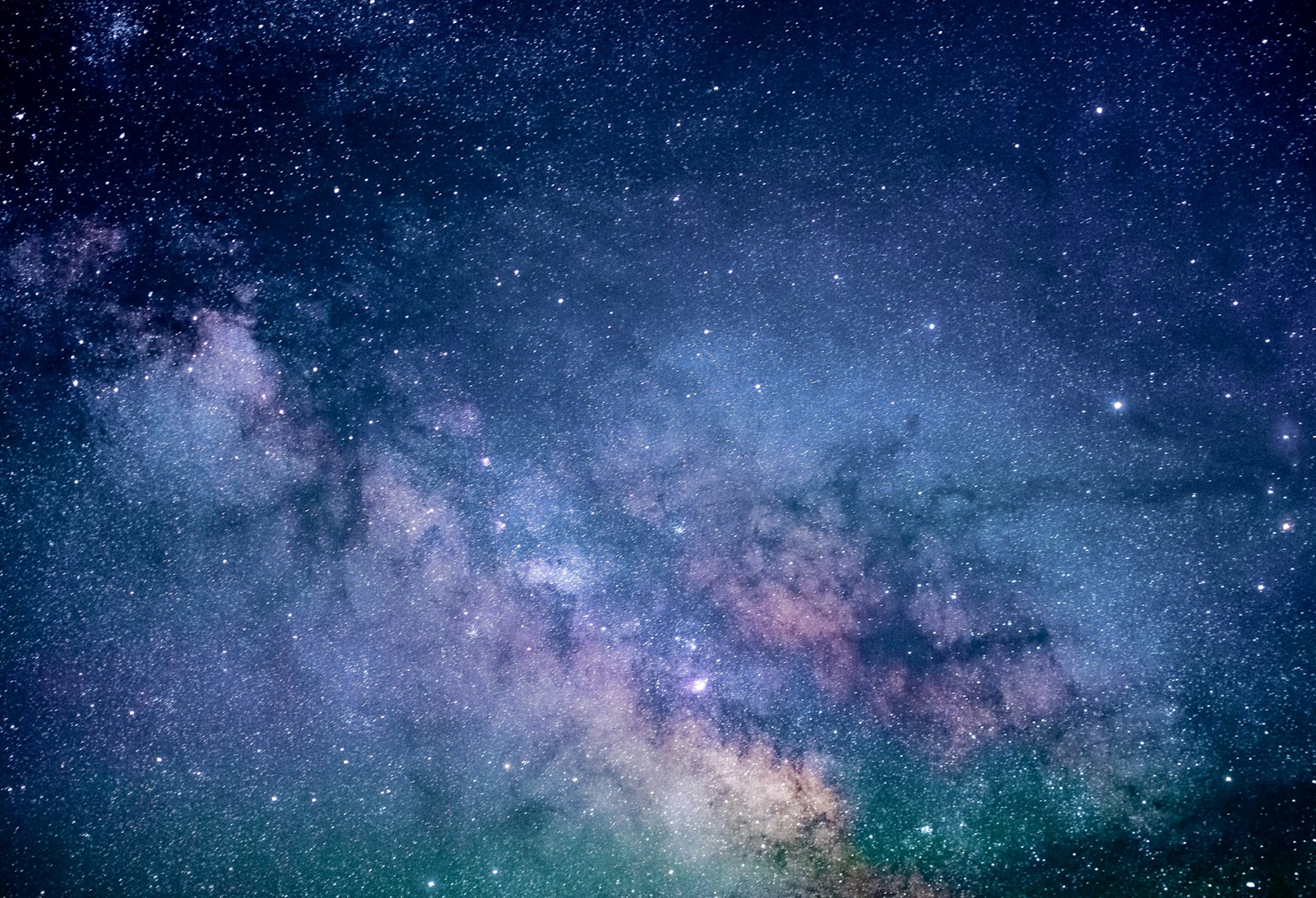 Night sky over arid ground with bright streaks.