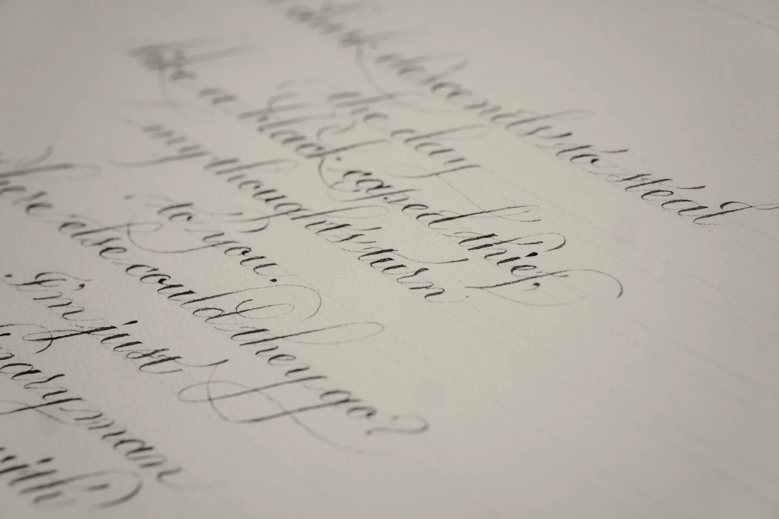 Copperplate script on cream paper, its swelling down strokes made by pressure on a pointed pen.