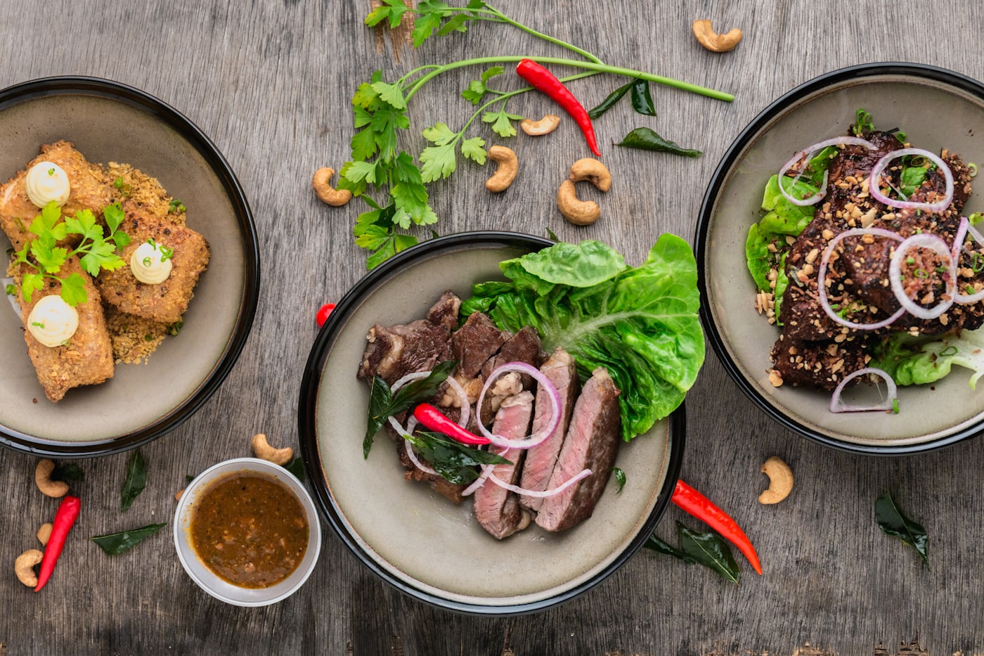 A richly plated feast on a dark table.