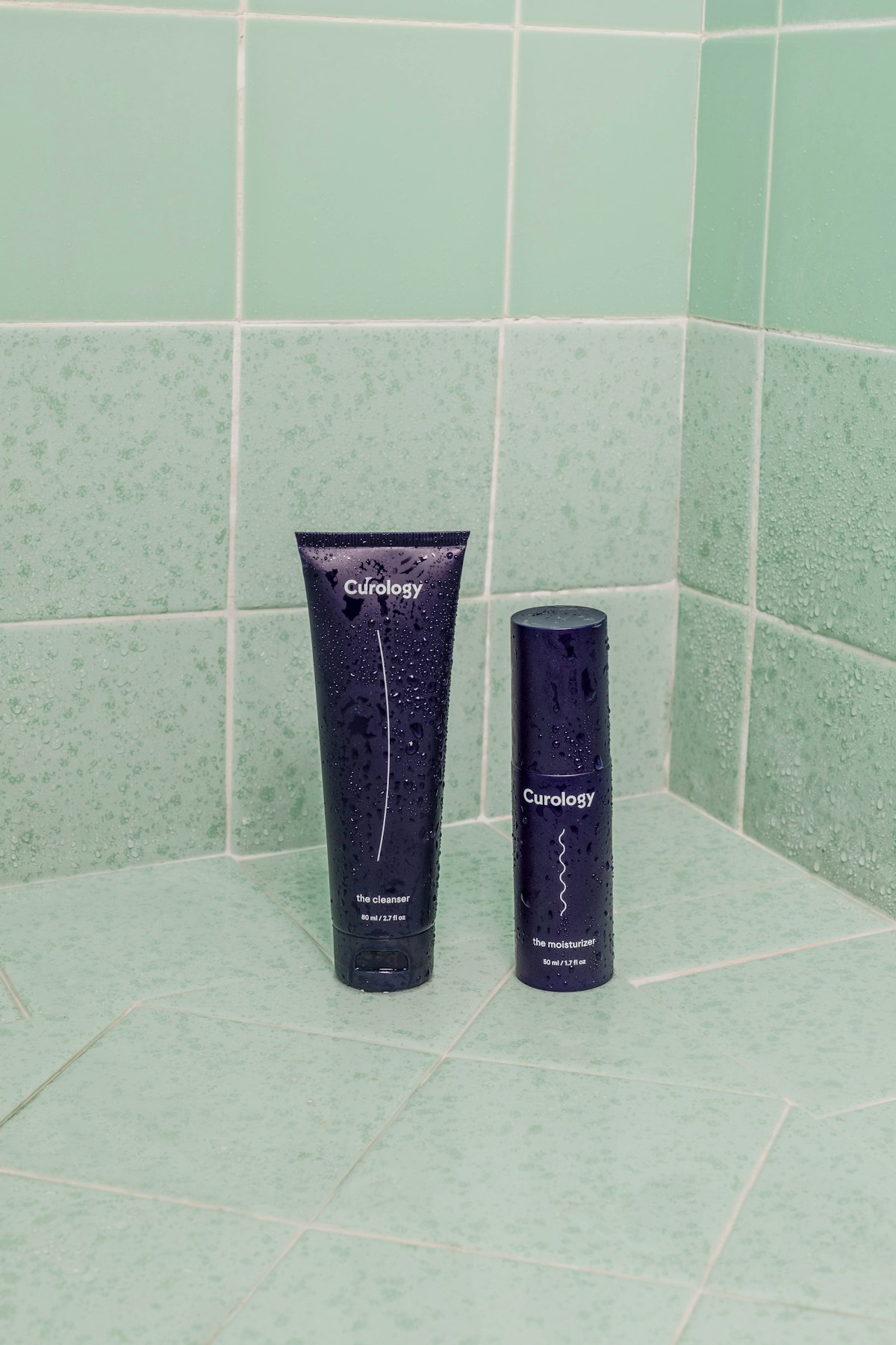 Soft cleanser foam and cotton pads on a pale surface.