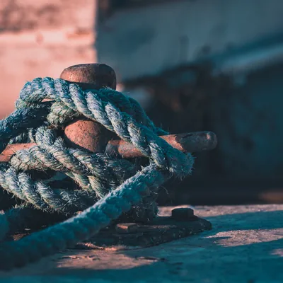 A mooring line made fast to a bronze cleat on the pontoon