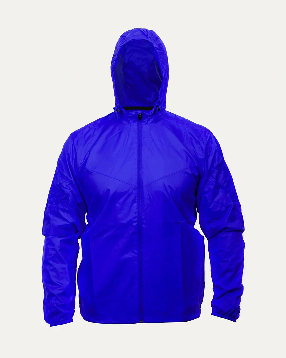 A runner in a hooded shell jacket and winter tights crossing deep snow below a pine forest.
