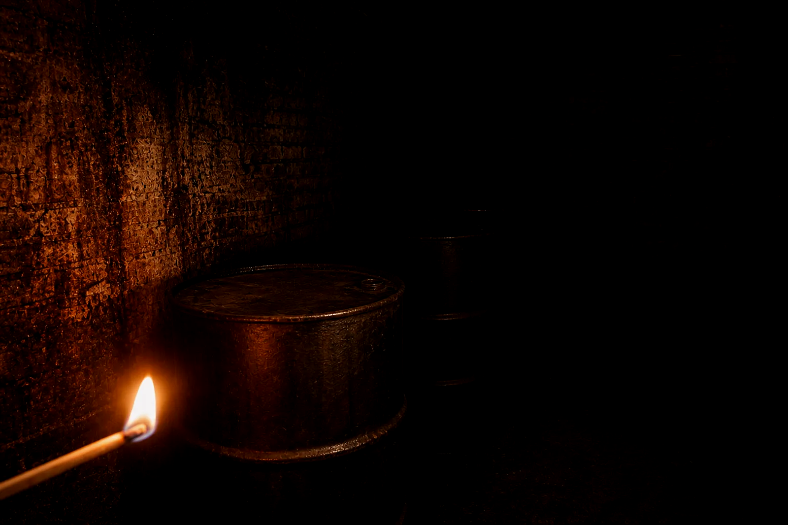 A small brick chemical vault with rust-brown stained walls and sealed iron drums.